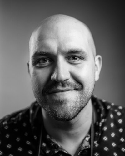 Black and white headshot of the wedding photographer