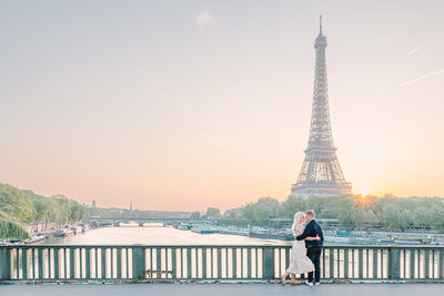 Couple embracing during Paris photoshoot with Eiffel tower and sunset in the background