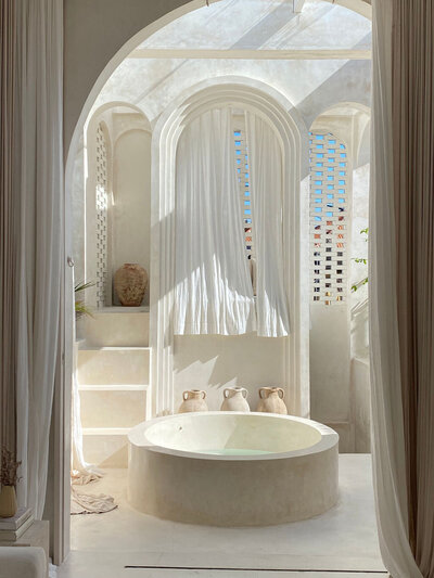 Elegant white bathroom with arched doorway, luxury lifestyle interior content