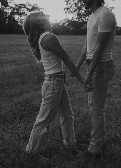 country field engagement photos that are romantic and at golden hour. Blue denim jeans and white shirts make for a casual session for save the dates