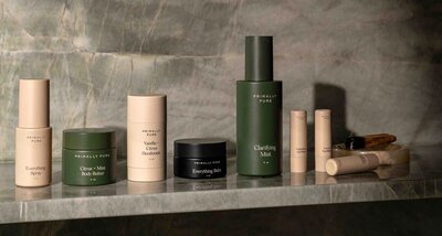 Primally Pure Dry Shampoo container with powder spread around it