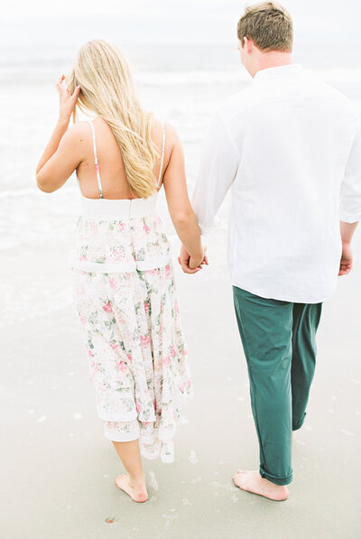 Film photo of couple walking on Folly Beach