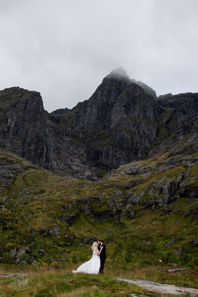 Couple hugging by a mountain