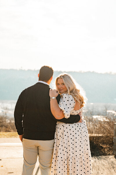 Romantic photo of a couple gazing out at a scenic view during their Kentucky engagement, capturing a quiet, intimate moment together.