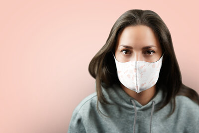 Girl wearing a Mockup of  branded mask