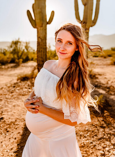 pregnant mom holding her belly for maternity portraits for phoenix photographer