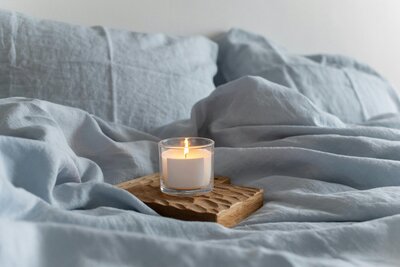 Candle on a bed