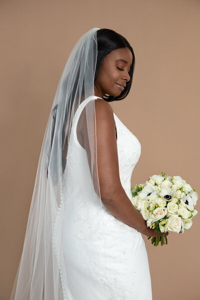 Bride wearing a chapel length veil with small serged edge