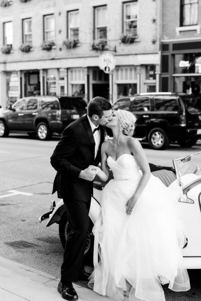 Bride and Groom Kissing on a street