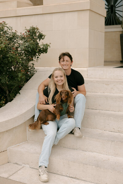 Kennedy and Tyler's engagement photos with their dog sitting on steps