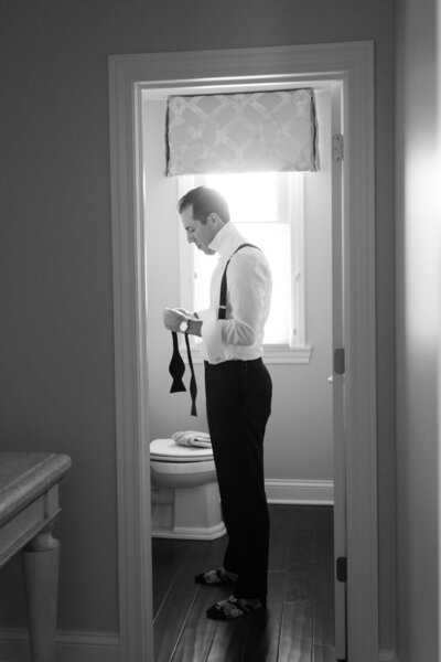 Groom about to put on his tie