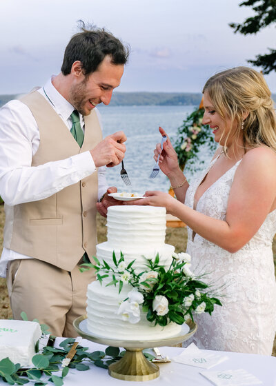 bride and groom cake cutting by puget sound outdoor reception