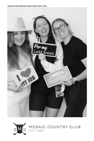 Friends having fun posing with photo props at event in Vancouver