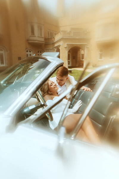 bride and groom laughing in a car