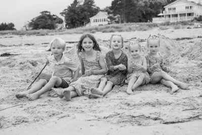 Kids sitting together on the sand | Family Photos