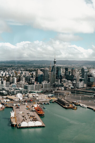 Aerial city and ocean views during Nikhil and Pranali’s helicopter proposal in Auckland, captured by Zanthe Vorsatz Photography.