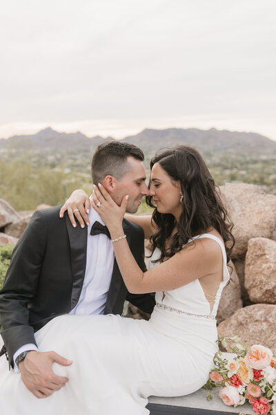Bride and groom embracing each other taken by Arizona wedding photographer and videographer.