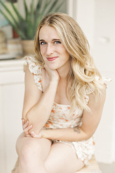 Shelby smiling in a floral dress