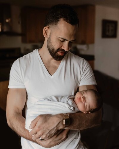 Dad holding newborn baby boy in chicago, IL by Taylor Lynn Studios