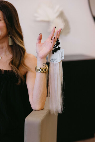 Hairstylist holding extension color swatch ring