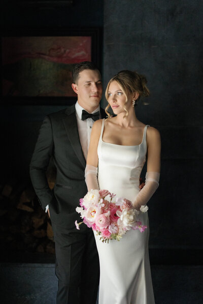 Grooms at altar of wedding ceremony in large domed building