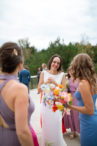 A bride tries on her modern dress with joy and excitement