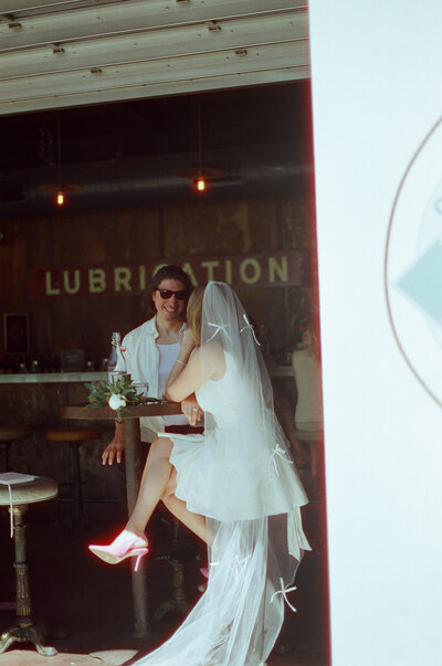 Elopement in Napa Valley at Tank Garage Winery shot on 35mm film. Bride in a short dress and long veil.