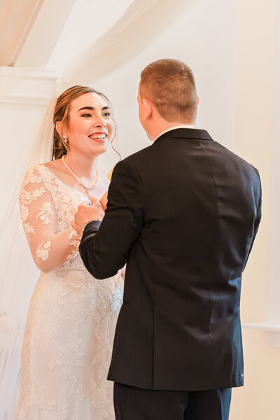 A newly wed couple smiling at each other during their fall destination wedding at The Hudson Manor by JoLynn Photography, a destination wedding photographer