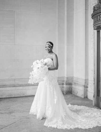 beautiful black bride in lace gown with white orchid bouquet in Detroit, Michigan