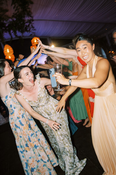 Maids of honor laughing on dance floor Glen Foerd Estate in Philadelphia, PA