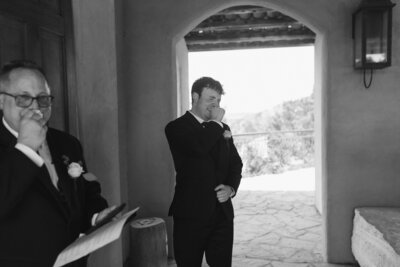 groom and father of the bride crying as bride walks down the aisle