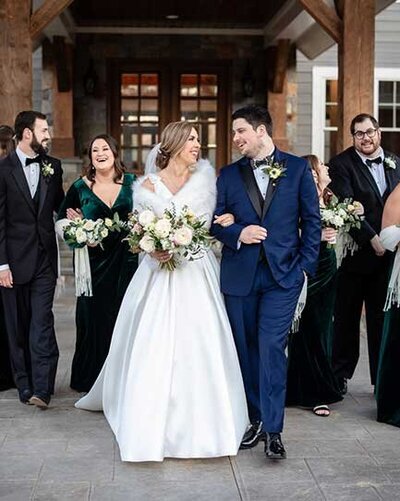 Just married couple in Richmond, Virginia pose with green velvet bridal party