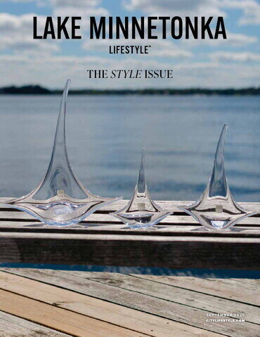 Front page of Lake Minnetonka Lifestyle Magazine featuring glass art in front of the lake. 