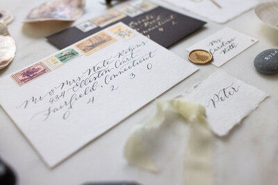 White envelope with black ink calligraphy and vintage postage