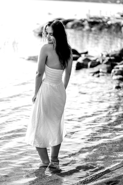 Black and White photo of girl with feet in water | Senior Session