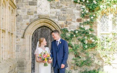 Summer wedding at Nymans National Trust. Couple in wedding attire in the walled gardens.