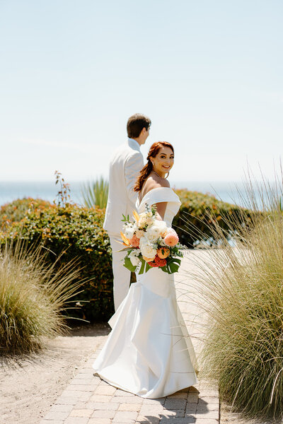 groom helping bride with her dress
