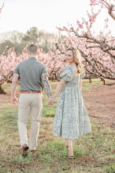 Pregnant wife holding husbands hand -Newborn Photography Greenville SC