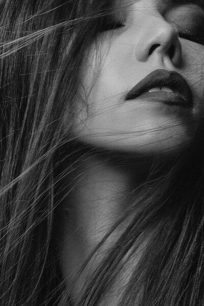 Beautiful woman lips and blown out hair.
