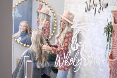 woman sitting in a salon chair smiling