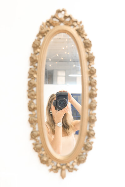 photographer taking photo in mirror