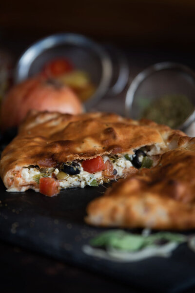 Golden-baked Redo’s panzerotti stuffed with melty cheese, olives, and fresh veggies—signature panzerottis in Yarmouth