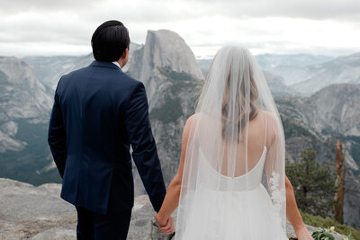 A bride and goom look at the beautiful lake view on their mammoth lakes wedding day. 