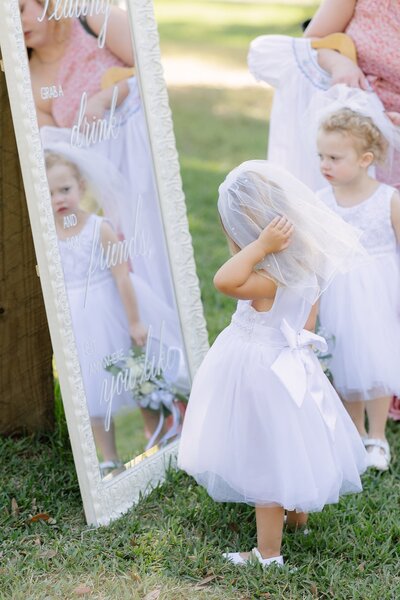 Flower girls looking in the mirror