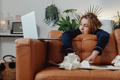 a woman on a coach looking at a computer