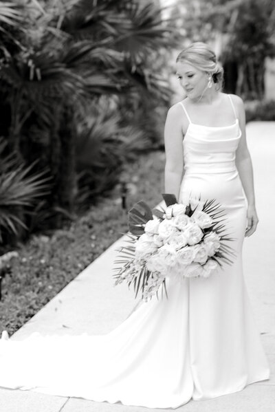 black and white image of bride posing with bouquet