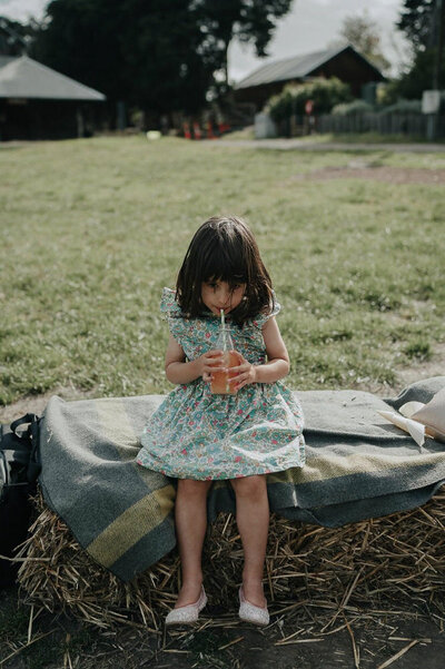 cute little girl having a drink at collingwood childrens farm ceremony