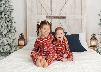 girls on bed in x-mas pajamas