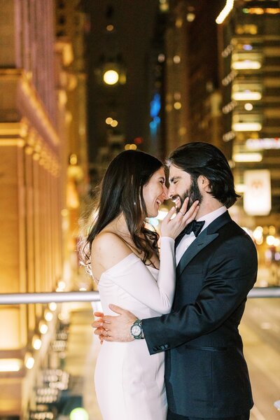 Bride and groom embracing on rooftop
