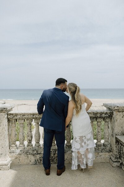 couple kisses on the beach